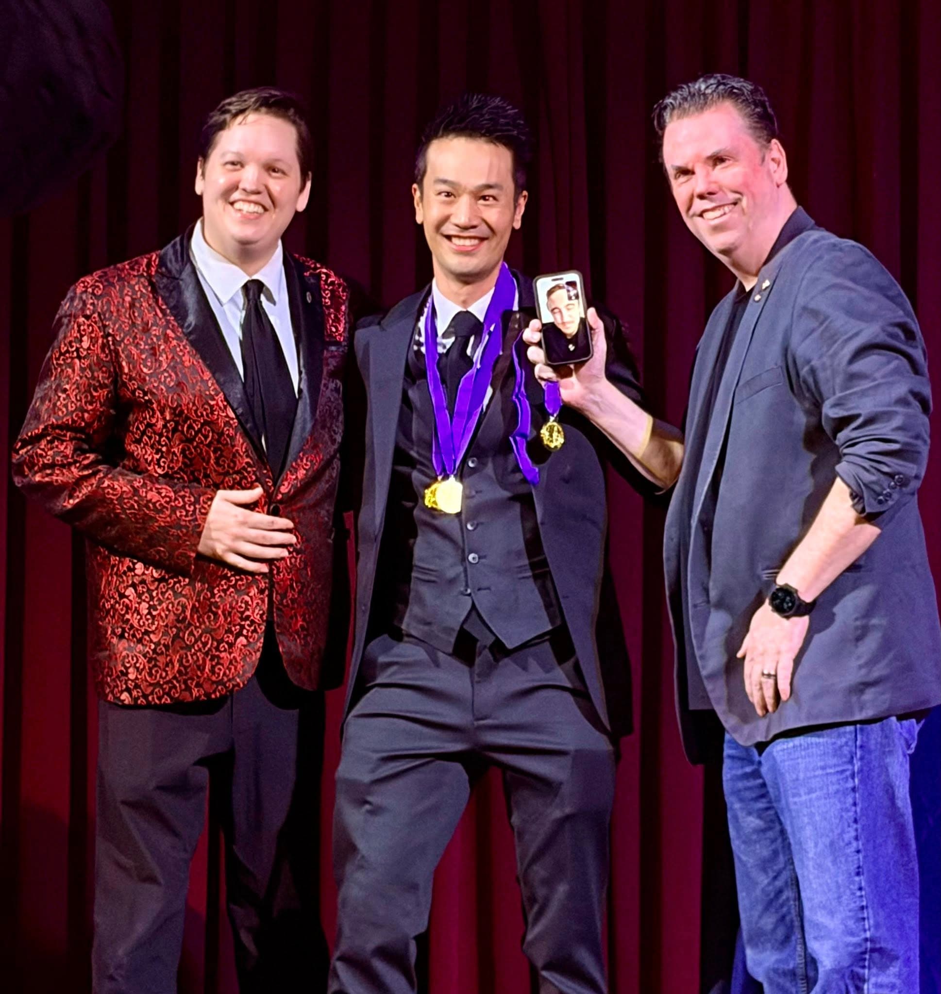 Kel wearing two PCAM 2026 gold medals after winning the Most Novel Magic Award