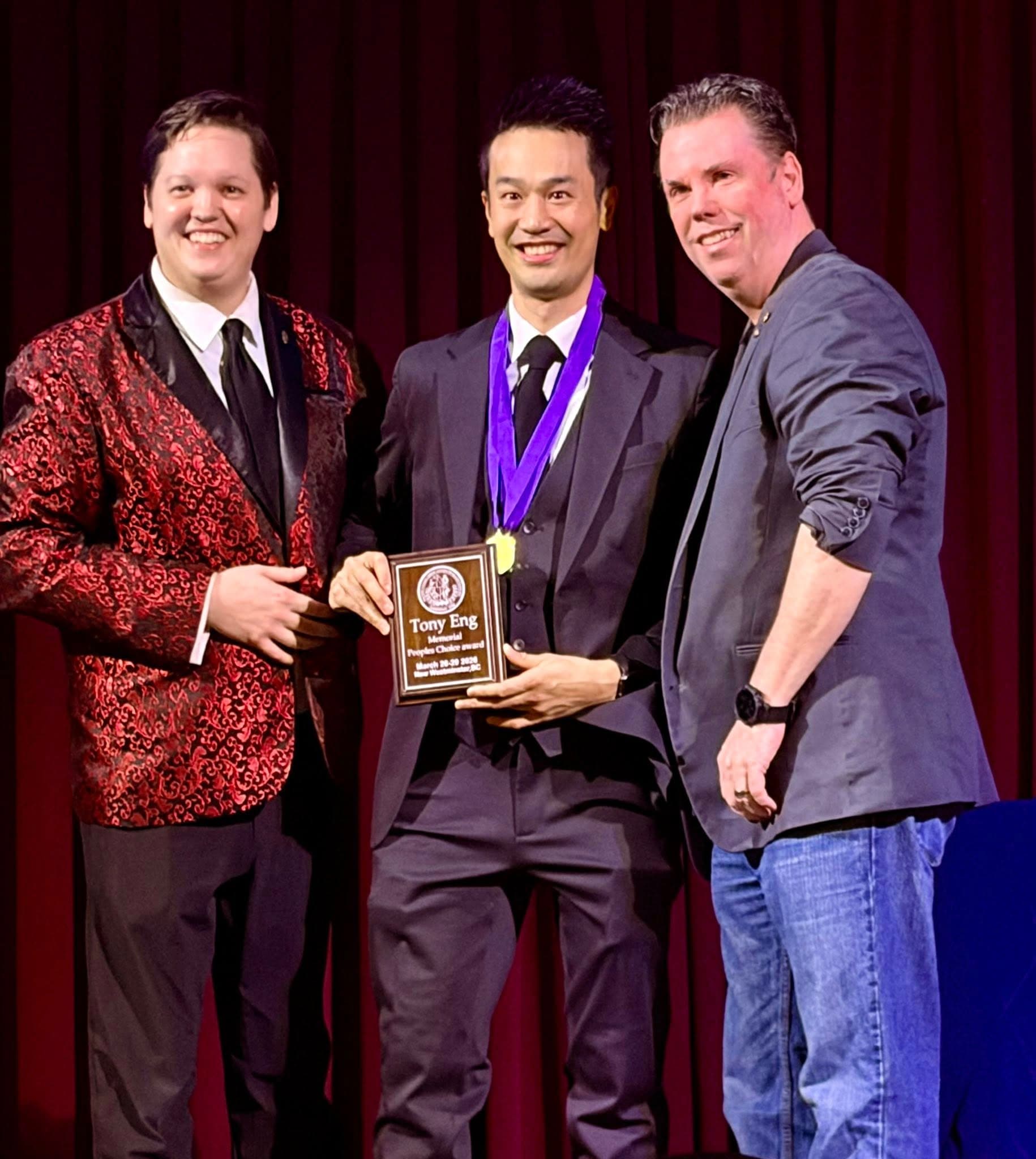 Kel accepting the Tony Eng Memorial People's Choice Award on stage