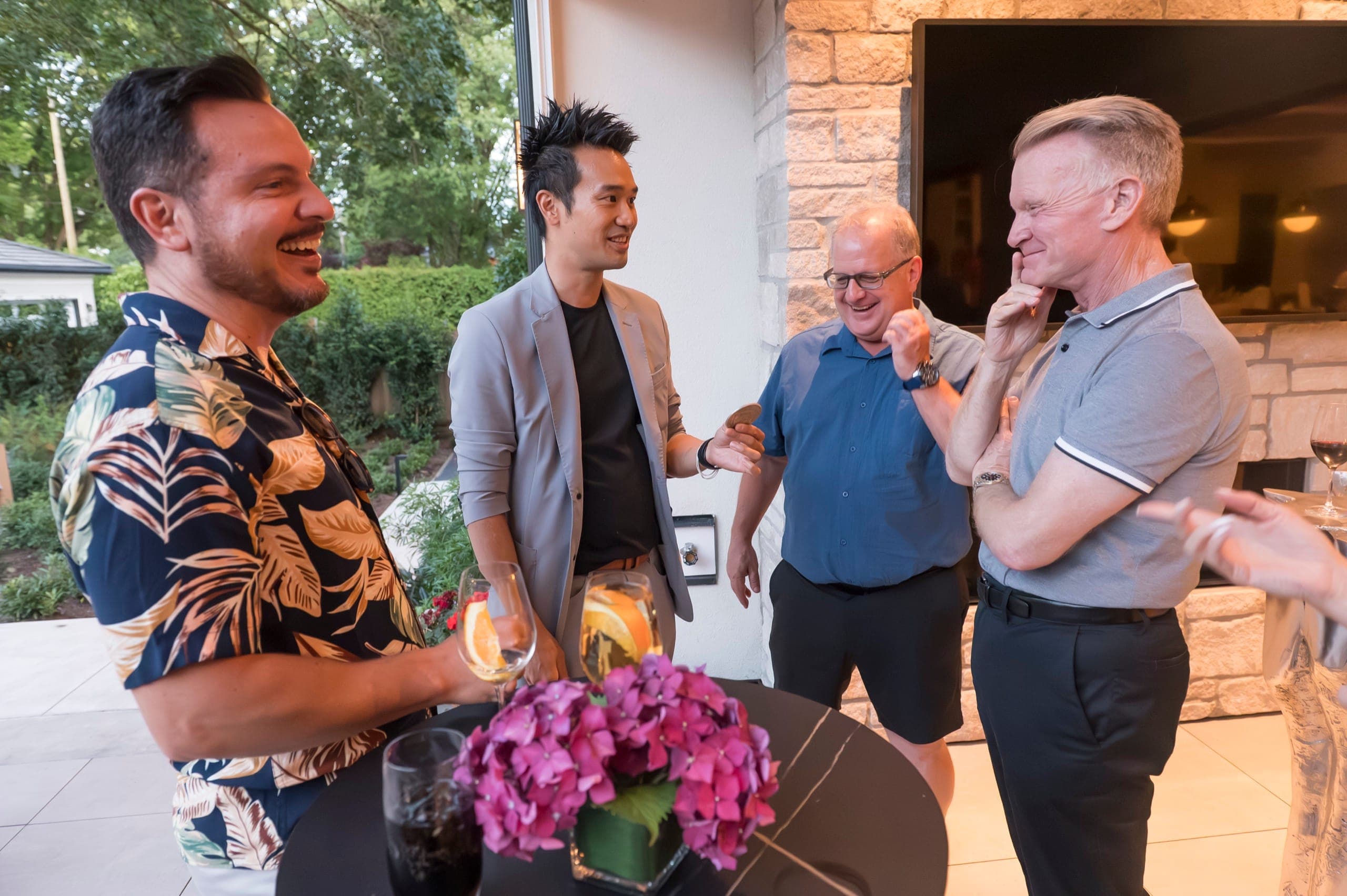 Three guests reacting differently to the same coin routine, one laughing and one working out how it was done