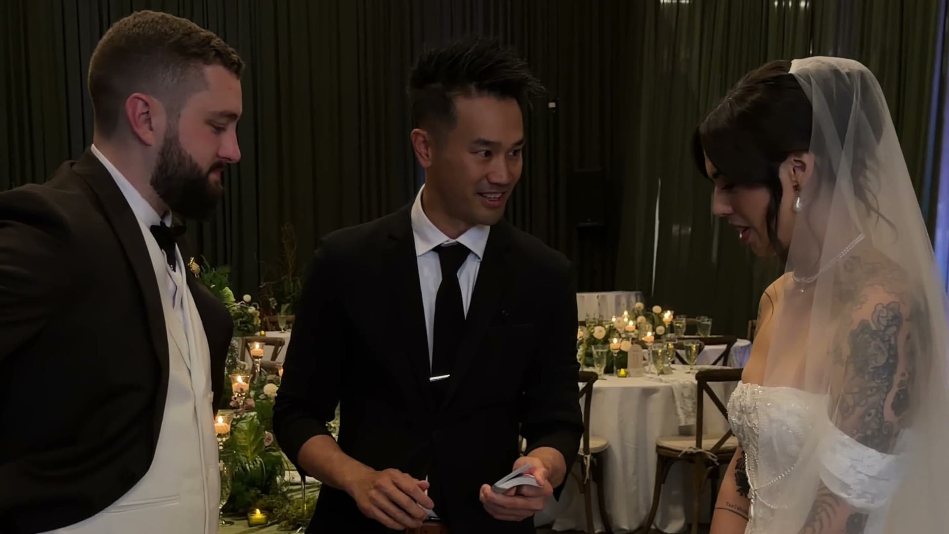 Kel performing card magic for Shiva and Conner at their wedding at The Pipe Shop, North Vancouver