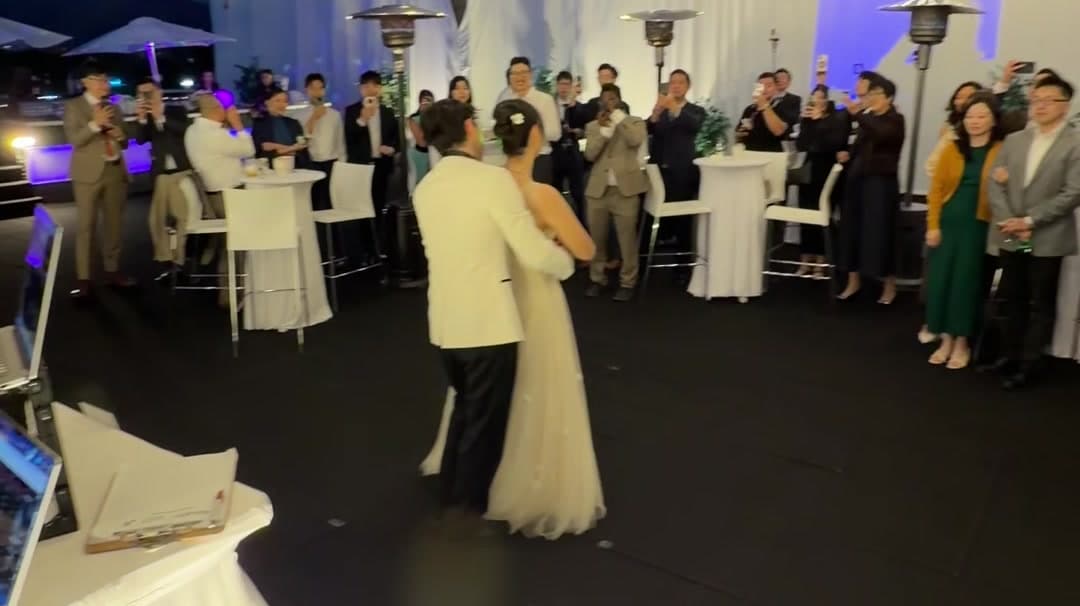 The bride on the dance floor as guests gather round at Sean and Anna's Vancouver wedding