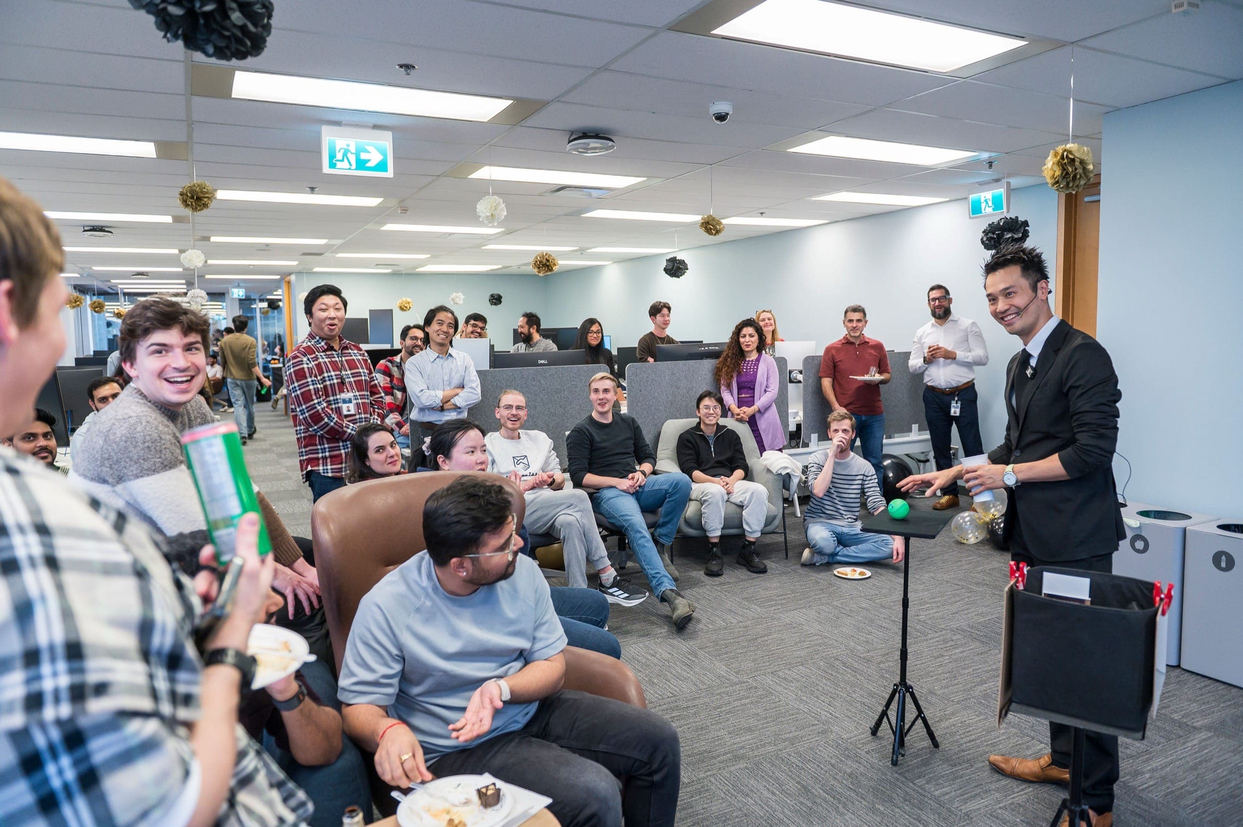 A seated conference audience watching a magic performance at a corporate event
