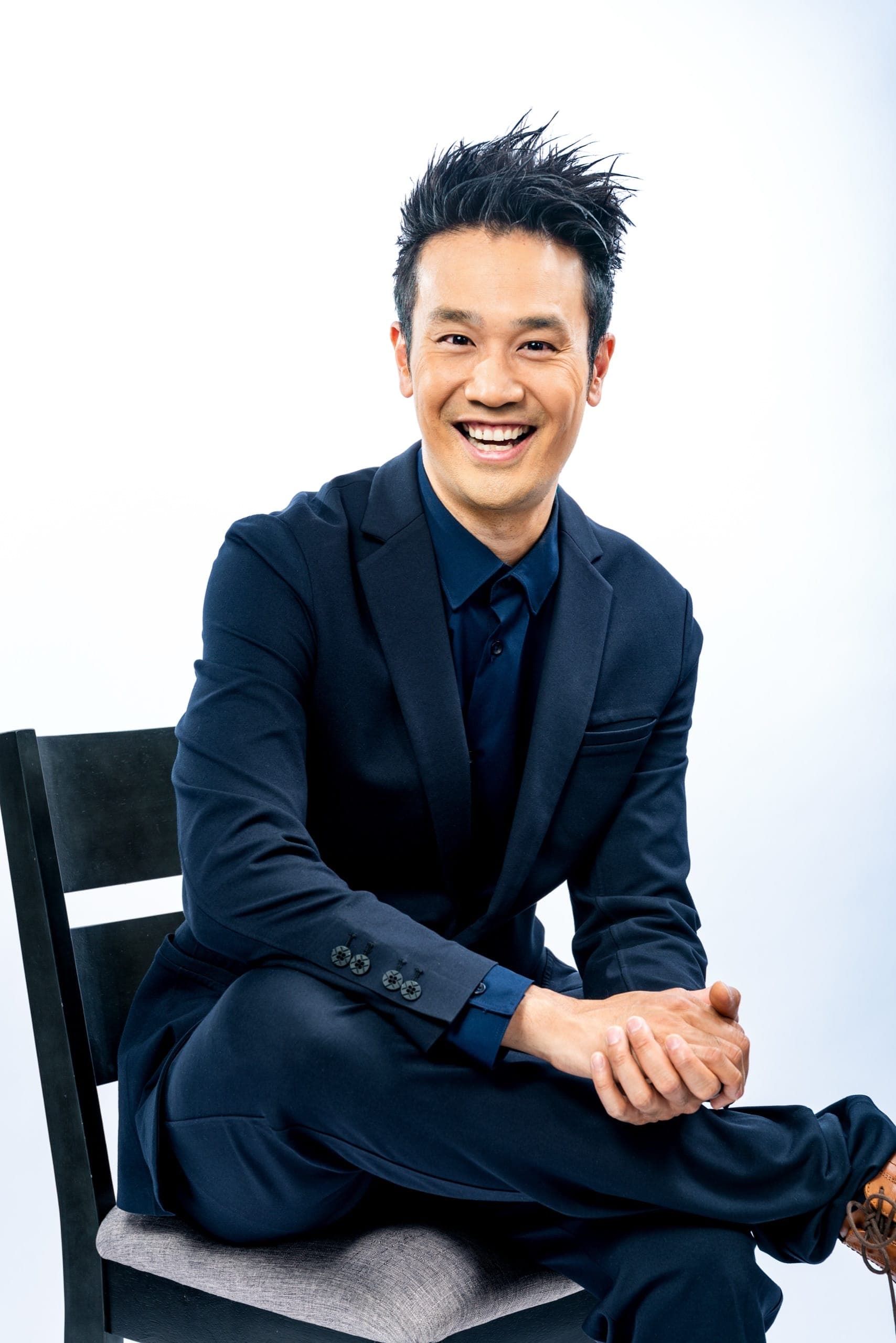 Kelvin Ng, Vancouver corporate magician, in a navy suit