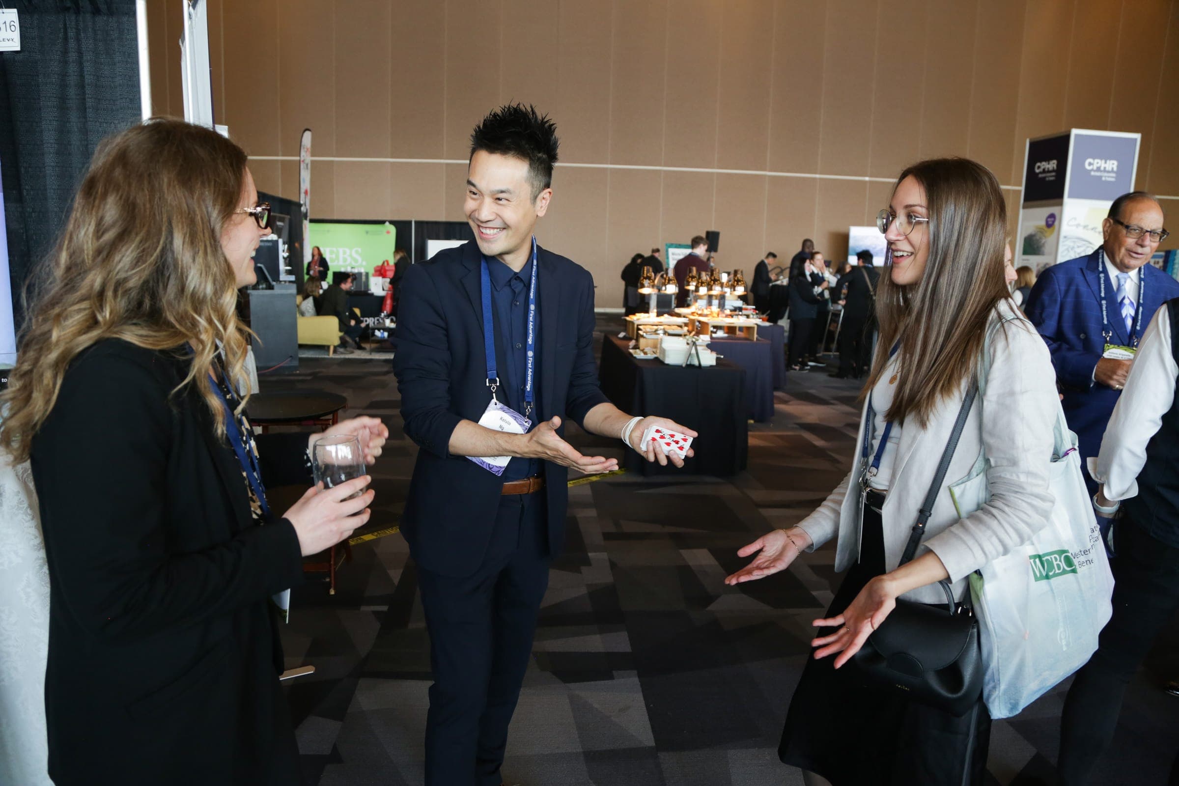 Kel performing close-up magic for guests at a conference reception near Coquitlam