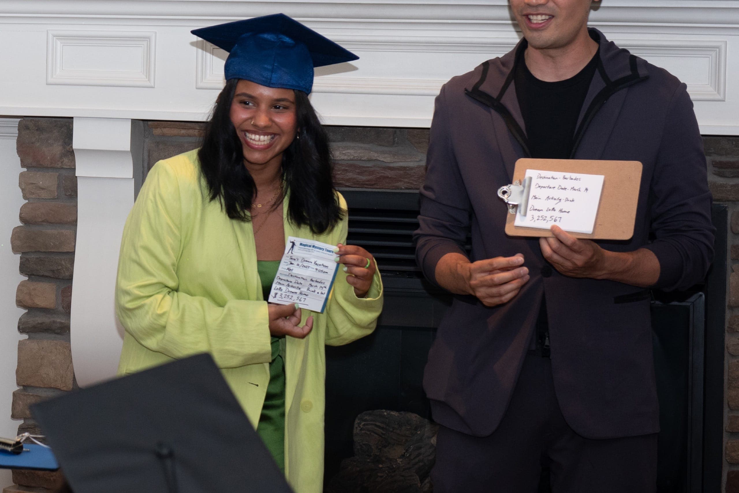 A grad holding up a matched prediction card during the stage show at a dry grad night