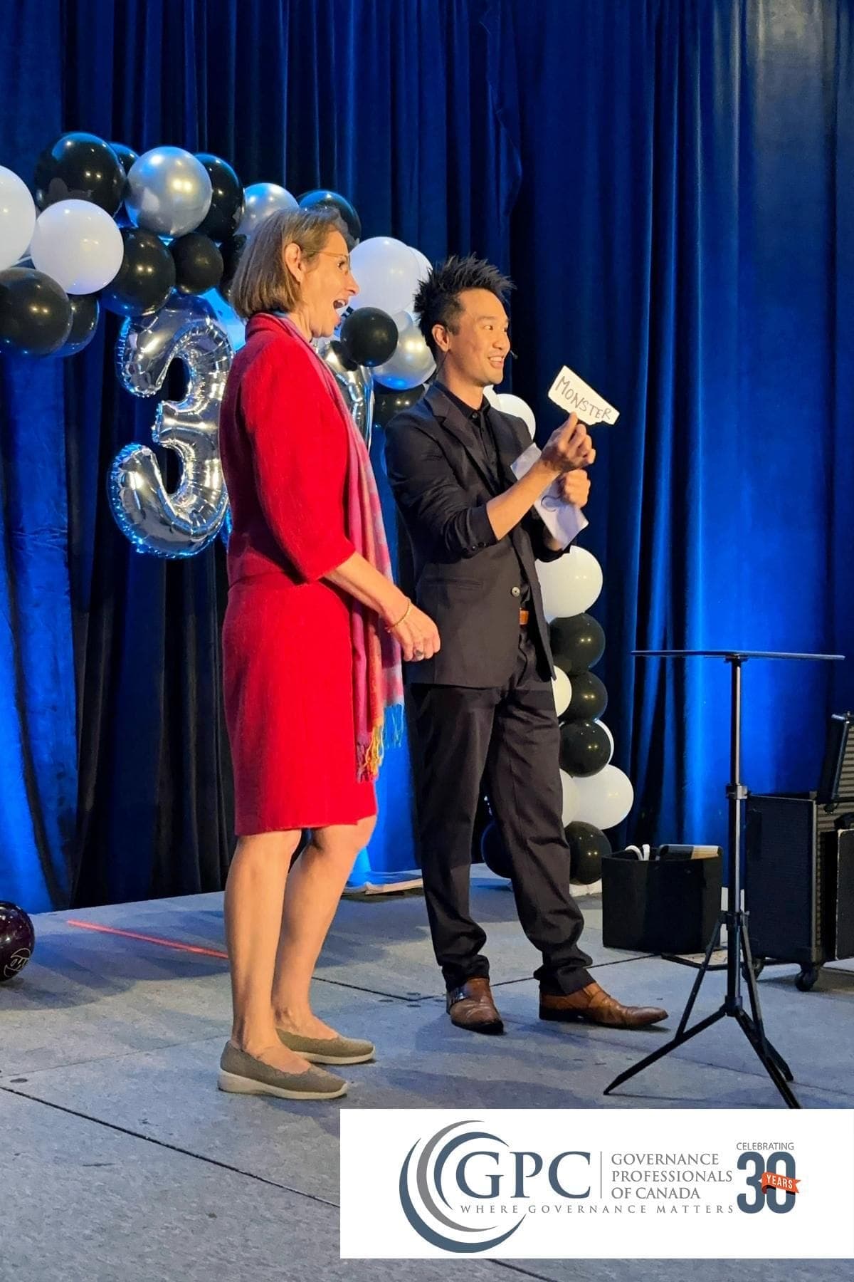 Kel performing on stage at a Governance Professionals of Canada event at the Fairmont Chateau Whistler