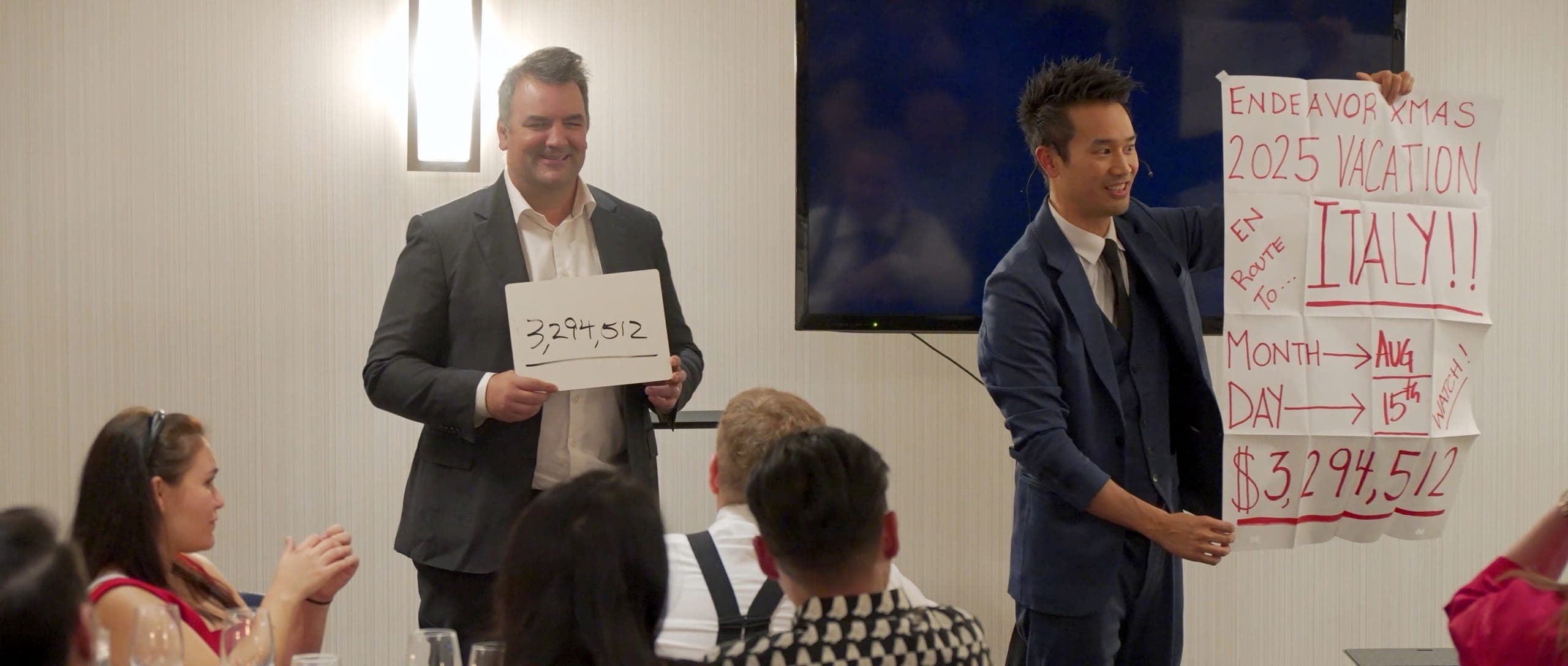 Kel revealing a written prediction that matches a guest's number at the Endeavour Silver evening in Vancouver