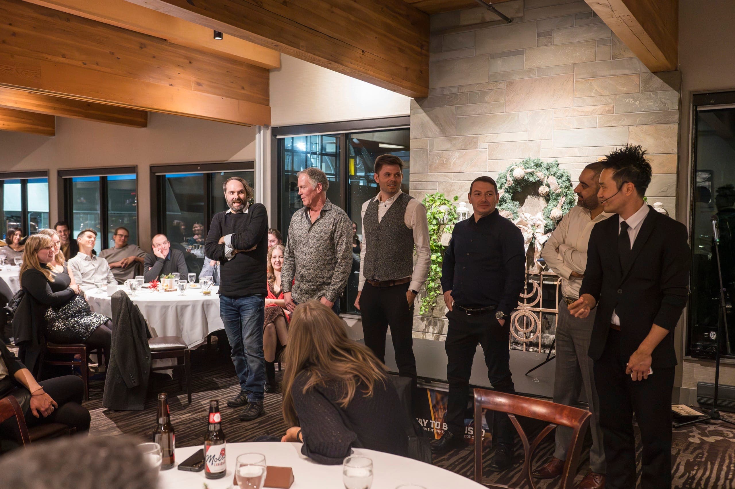 A line of volunteers on stage during a magic show at a Vancouver resource industry event