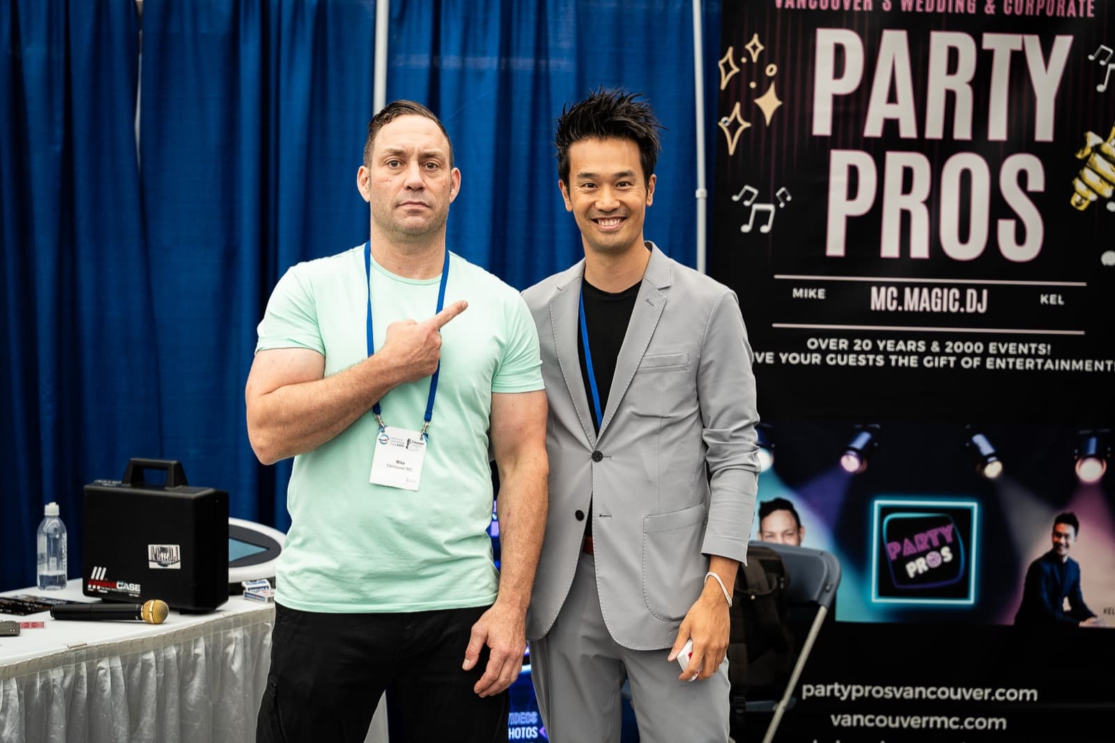 Mike Oulton and Kel standing together in front of the Party Pros banner at a Vancouver wedding and corporate expo