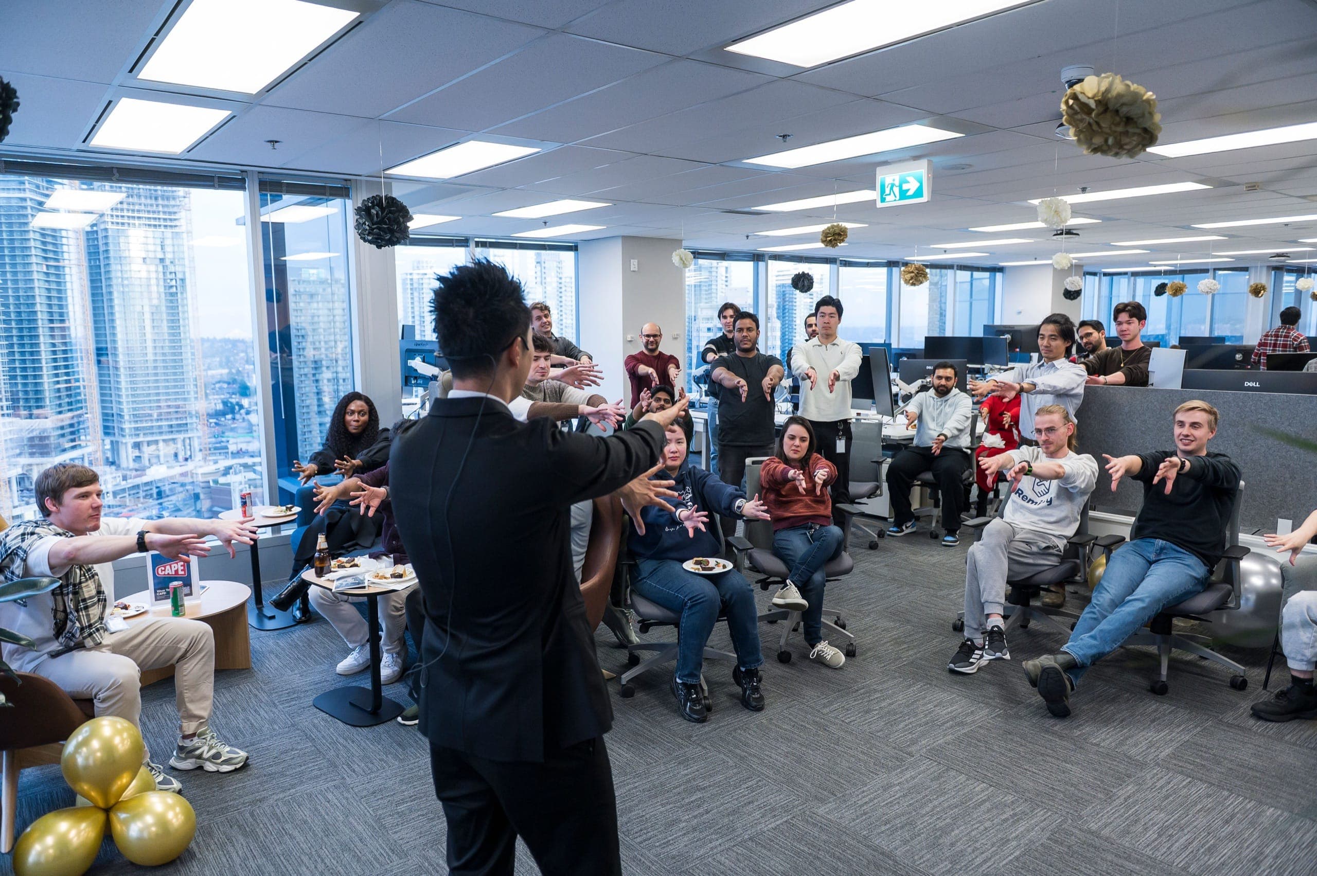 Kel performing a group routine for staff at a corporate conference reception