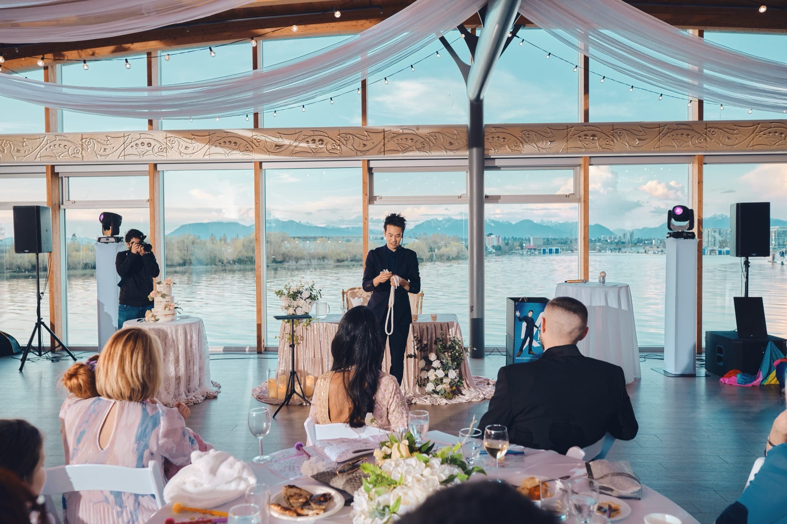 Kel performing a rope routine at golden hour with mountains and water behind him at Sharon and Regan's Vancouver wedding