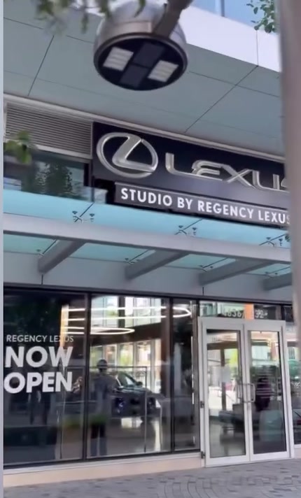 The entrance of Studio by Regency Lexus on Kingsway in Burnaby with a Now Open sign in the window