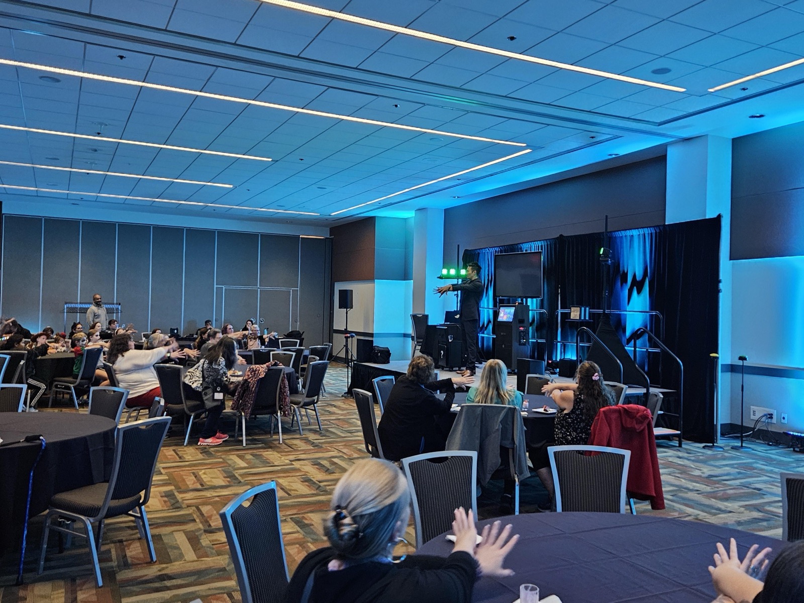 HEU members watching Kel's feature magic show in a meeting room at the Vancouver Convention Centre