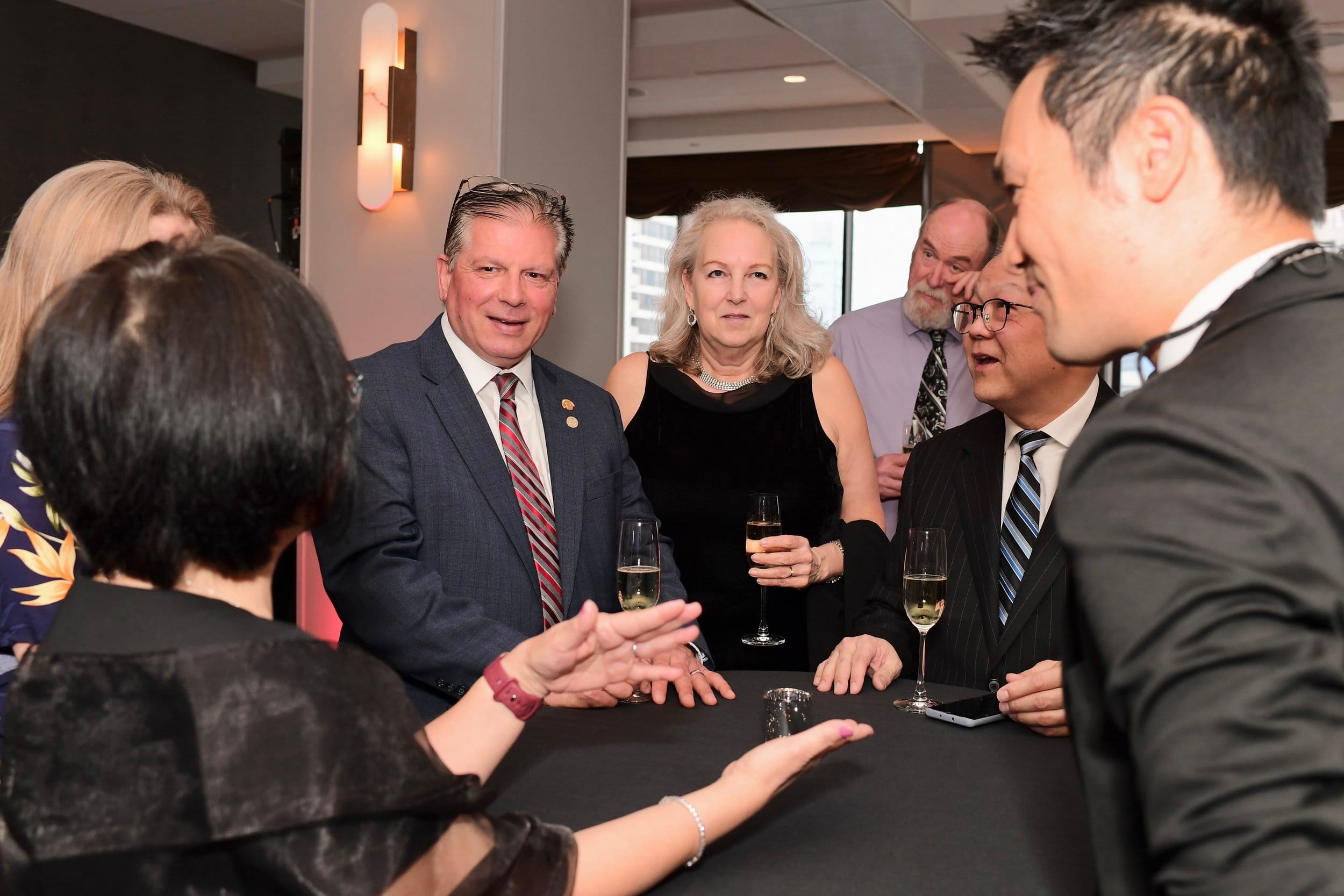 Corporate magician Kelvin Ng performing close-up magic for guests during cocktail hour at Sun Life Excellence Cup Fairmont Hotel Vancouver
