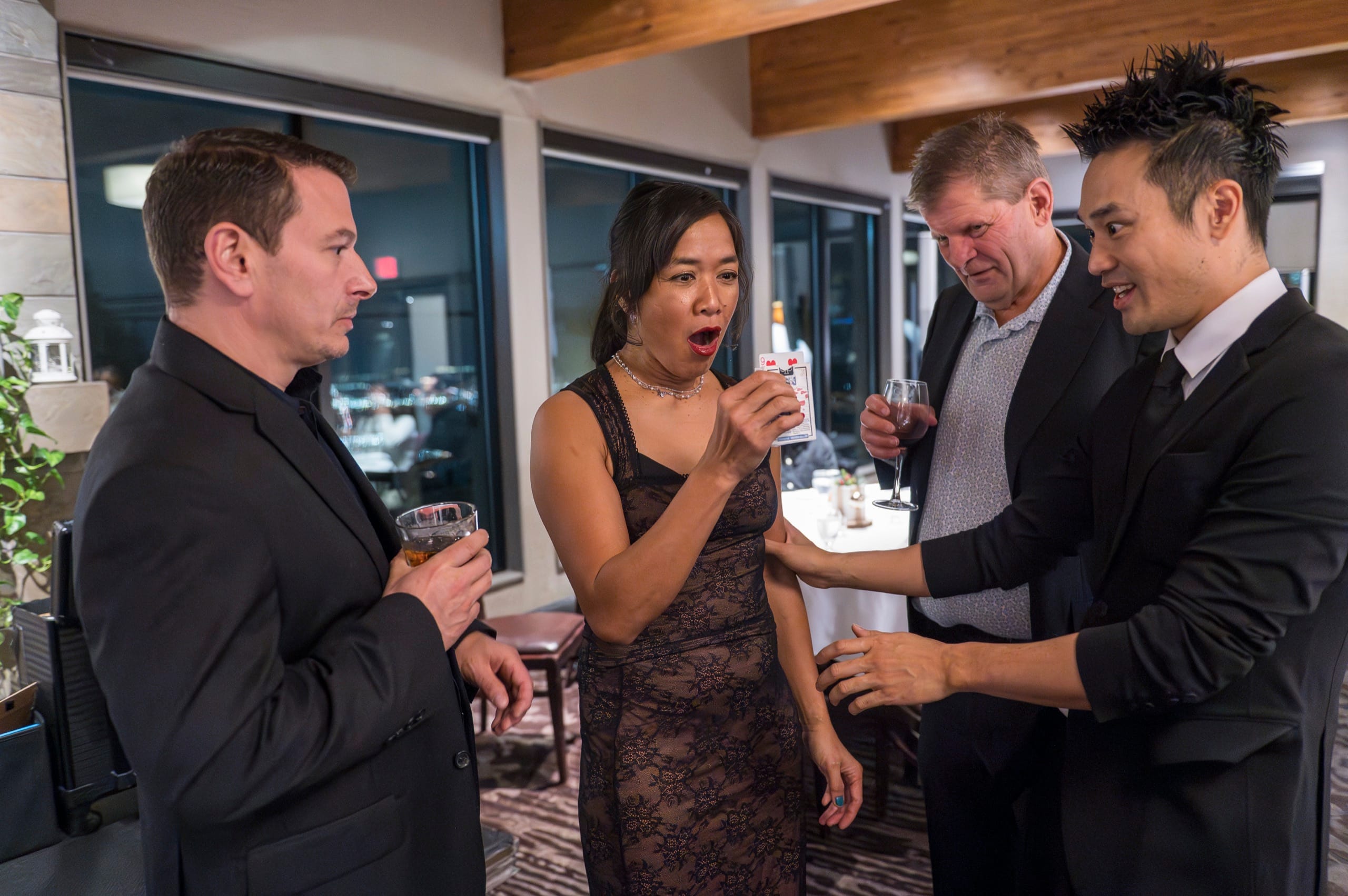 Guests in a cocktail circle reacting with astonishment during a mentalism performance in Vancouver