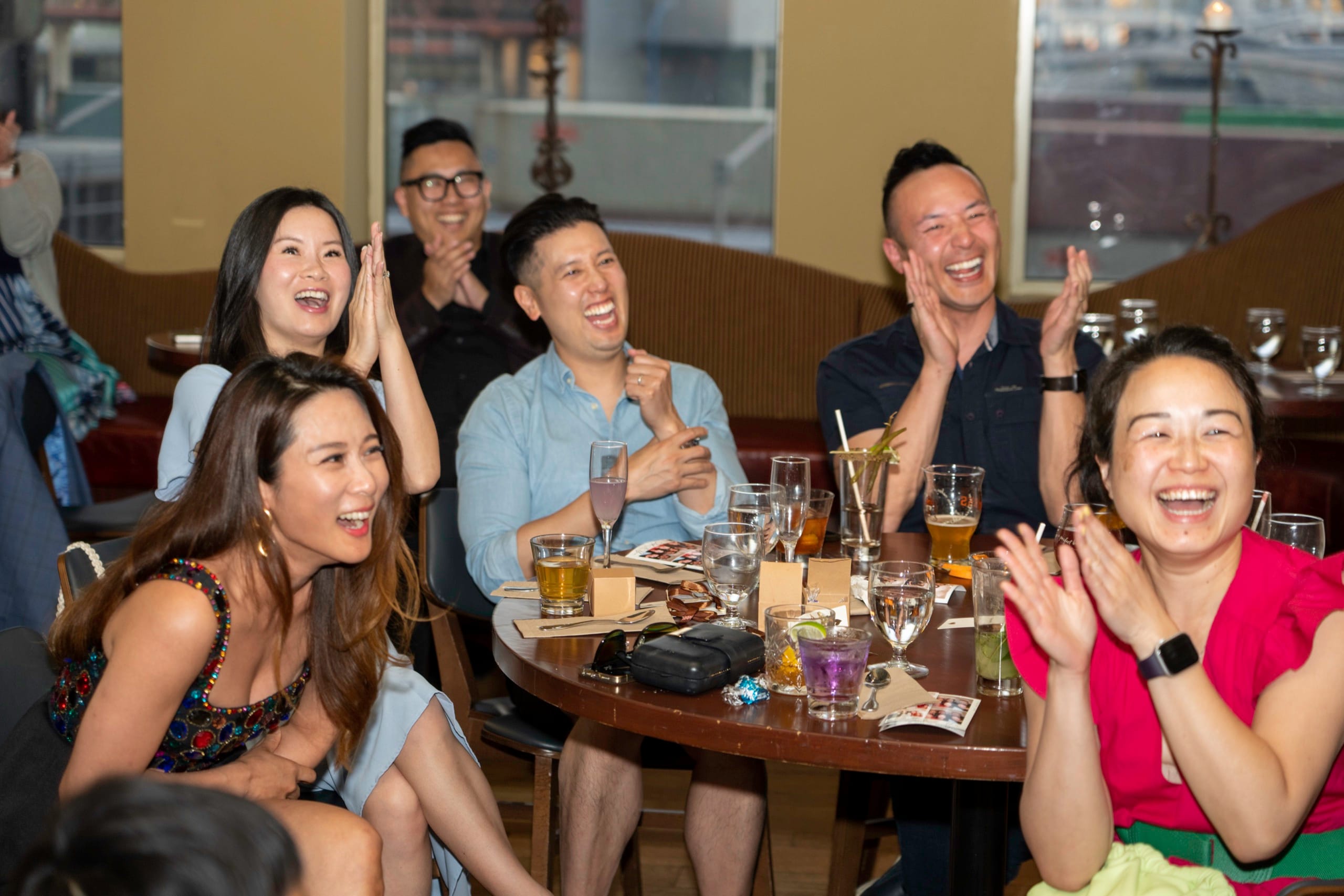 A wedding guest reacting with delight to close-up magic during a Vancouver cocktail hour